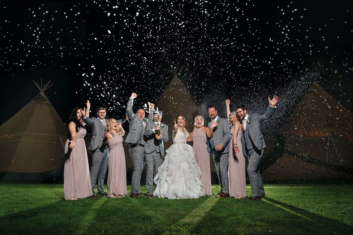 A wedding party cheers in this nighttime shot taken in the rain