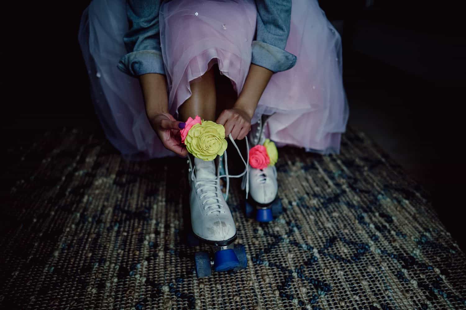 A bride laces up her roller skates for a fun-filled wedding reception