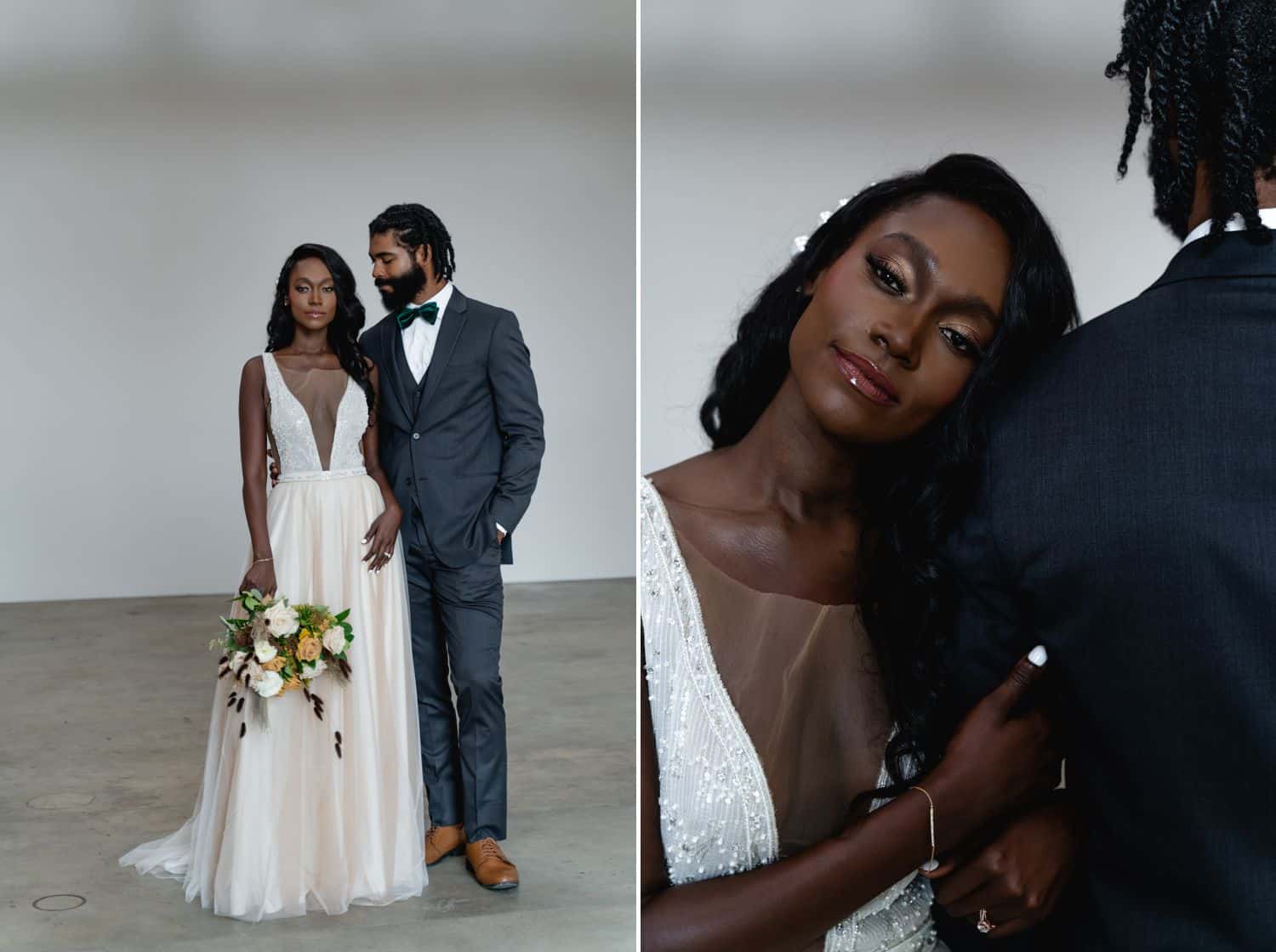 A Black bride and groom stand in a dimly lit studio in front of a white backdrop.